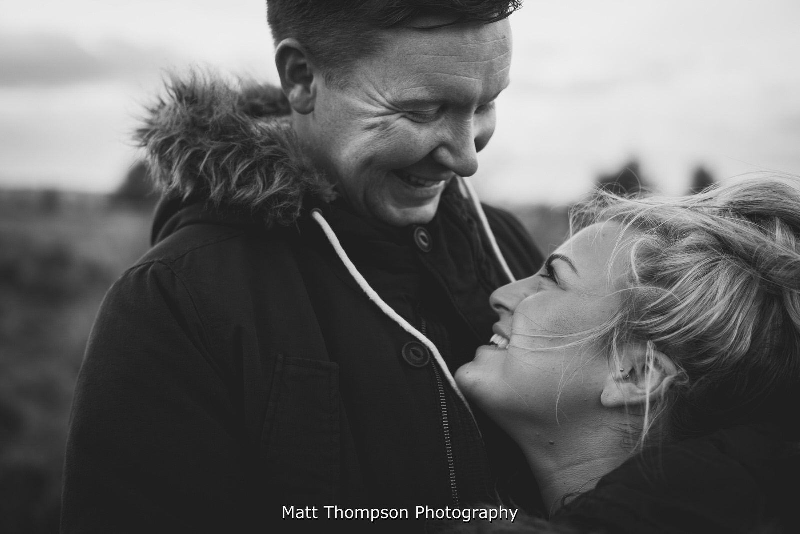couple smile on their engagement photoshoot