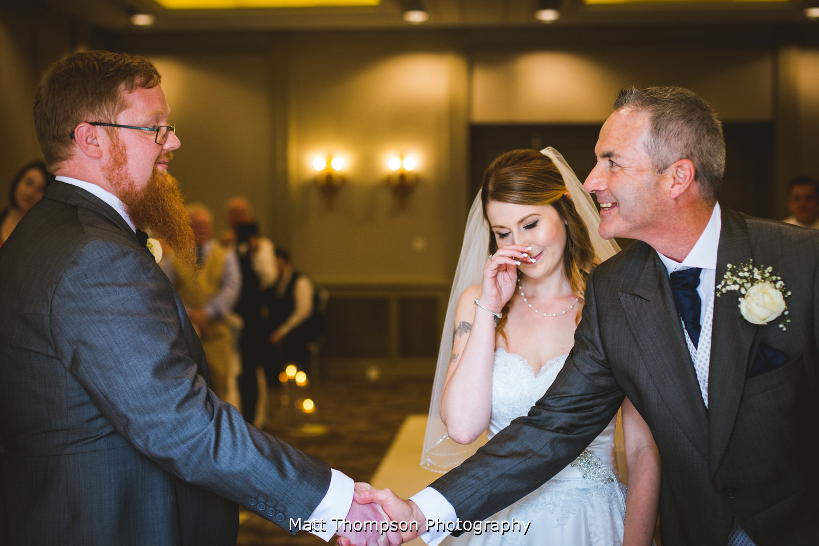 father of the bride and groom shaking hands