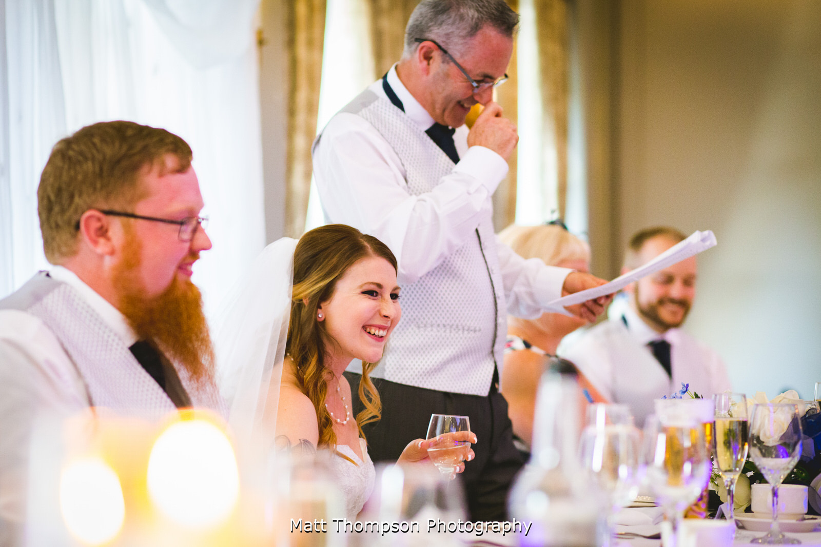 bride laughing at wedding speech