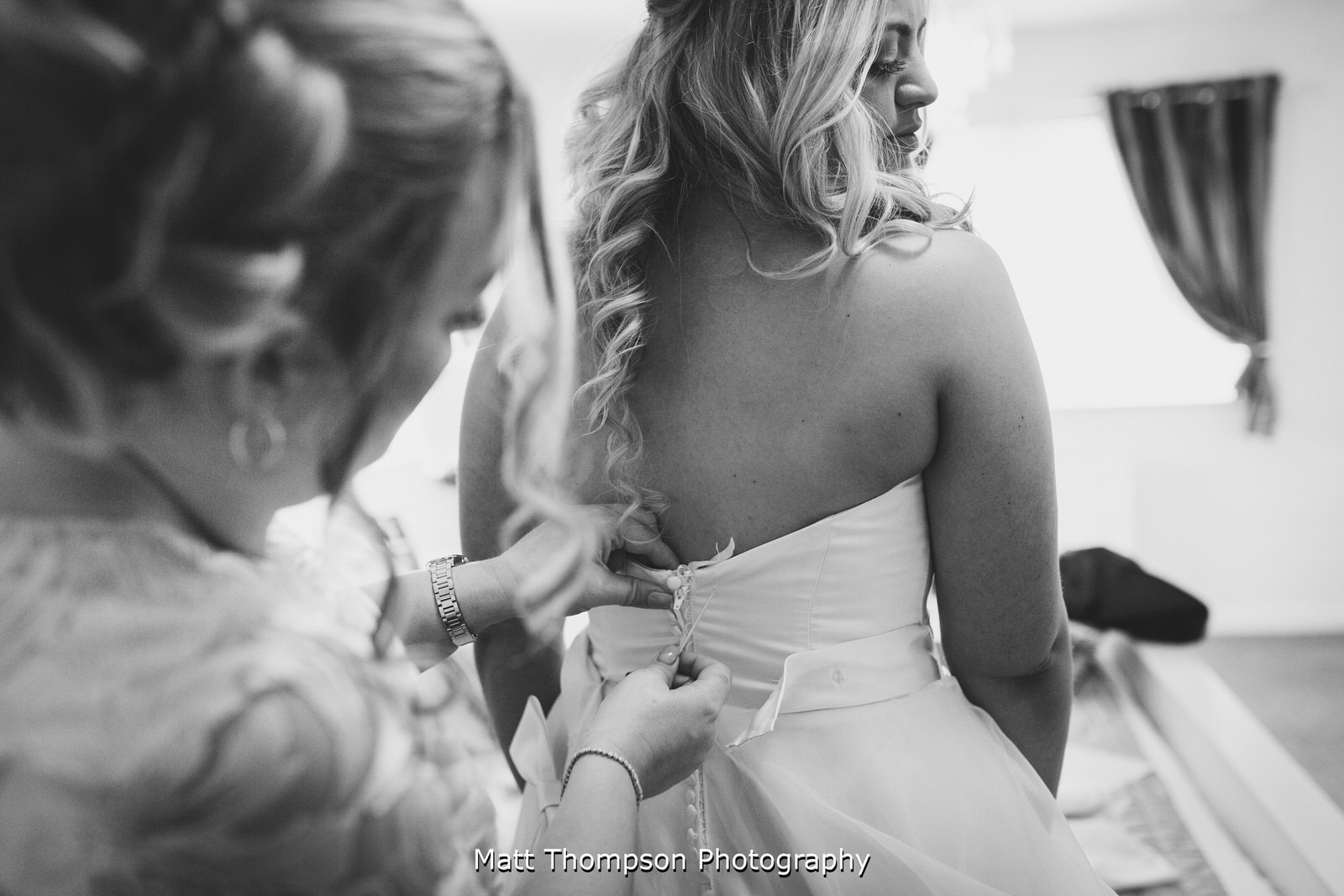 buttoning the wedding dress up