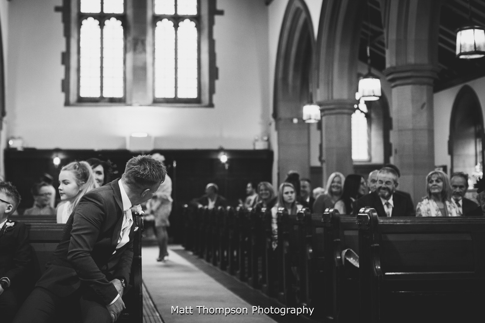 groom looking down the church isle
