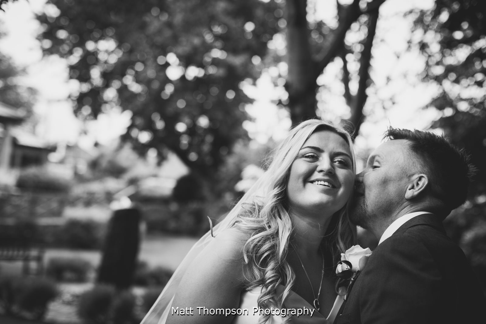 groom whispering in brides ear