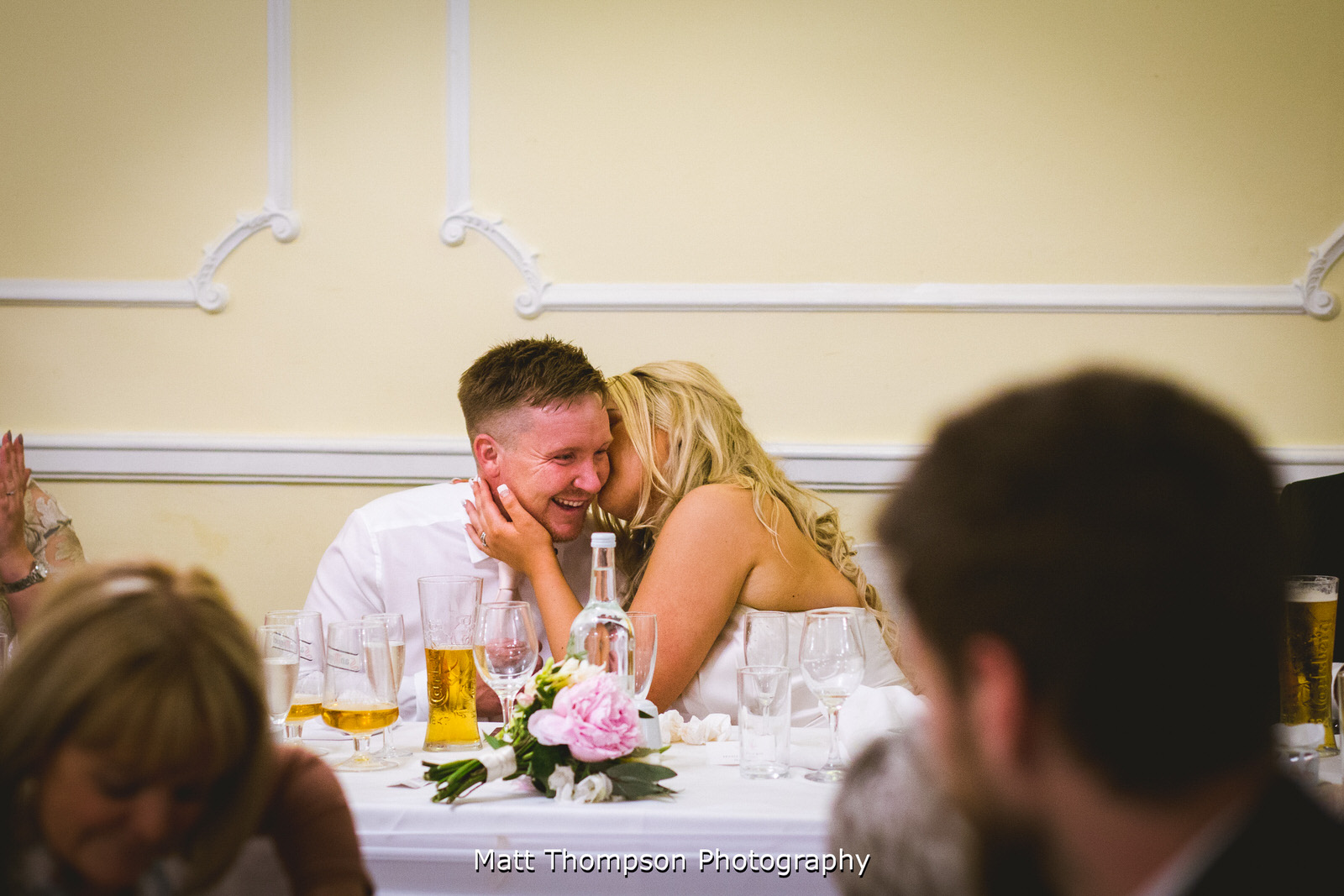 bride whispering in grooms ear
