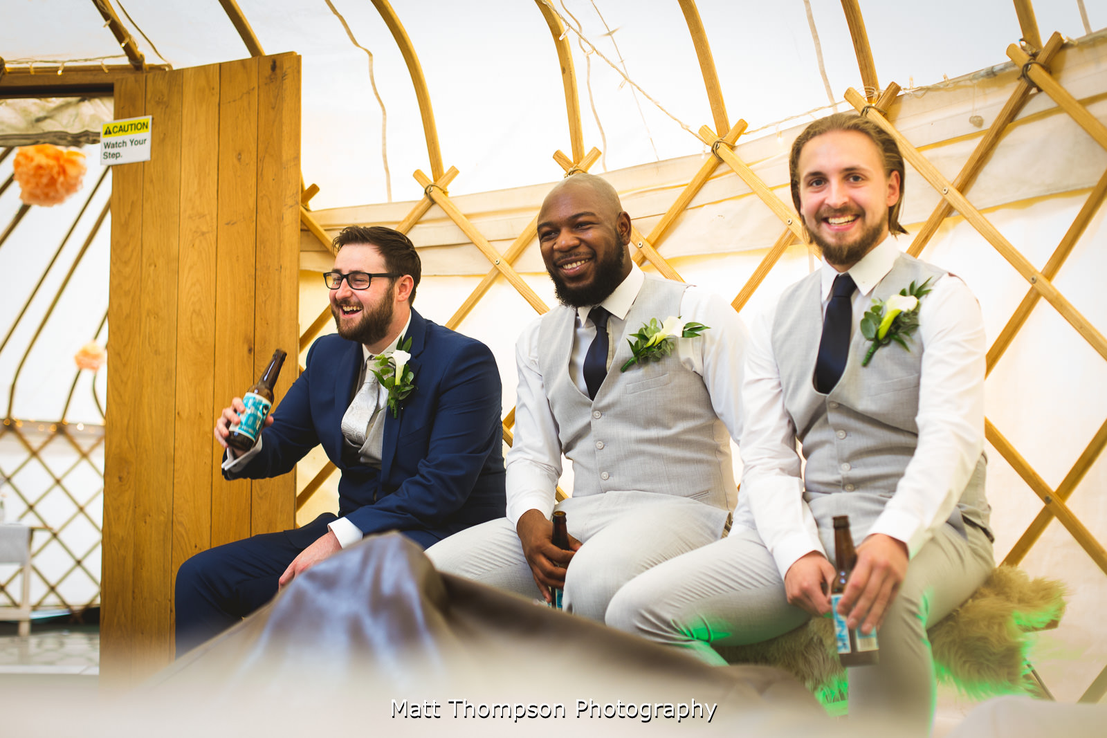 groomsmen drinking in a yurt