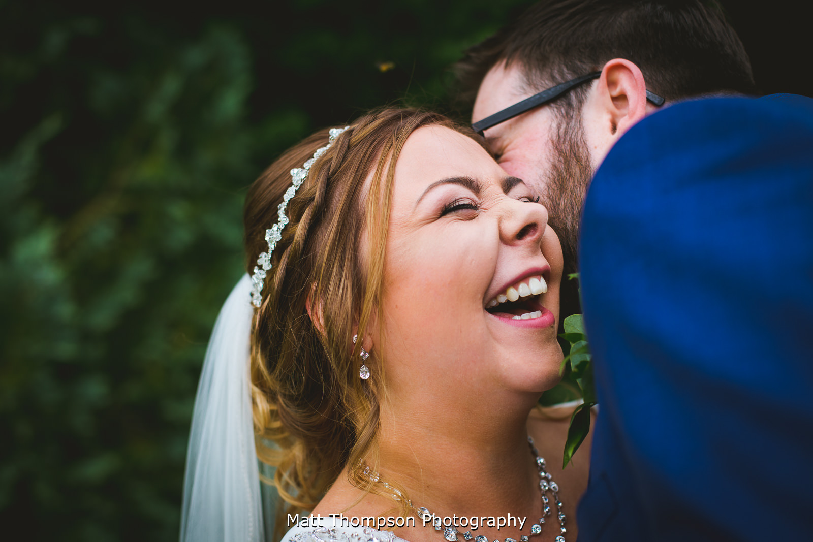 groom making bride laugh