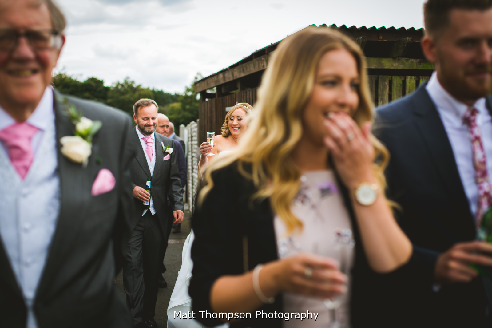 bride and groom walking with guests