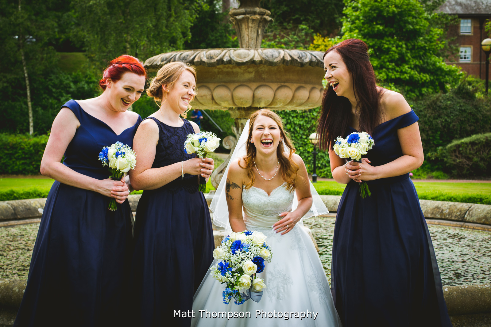bride and bridesmaids in fits of laughter