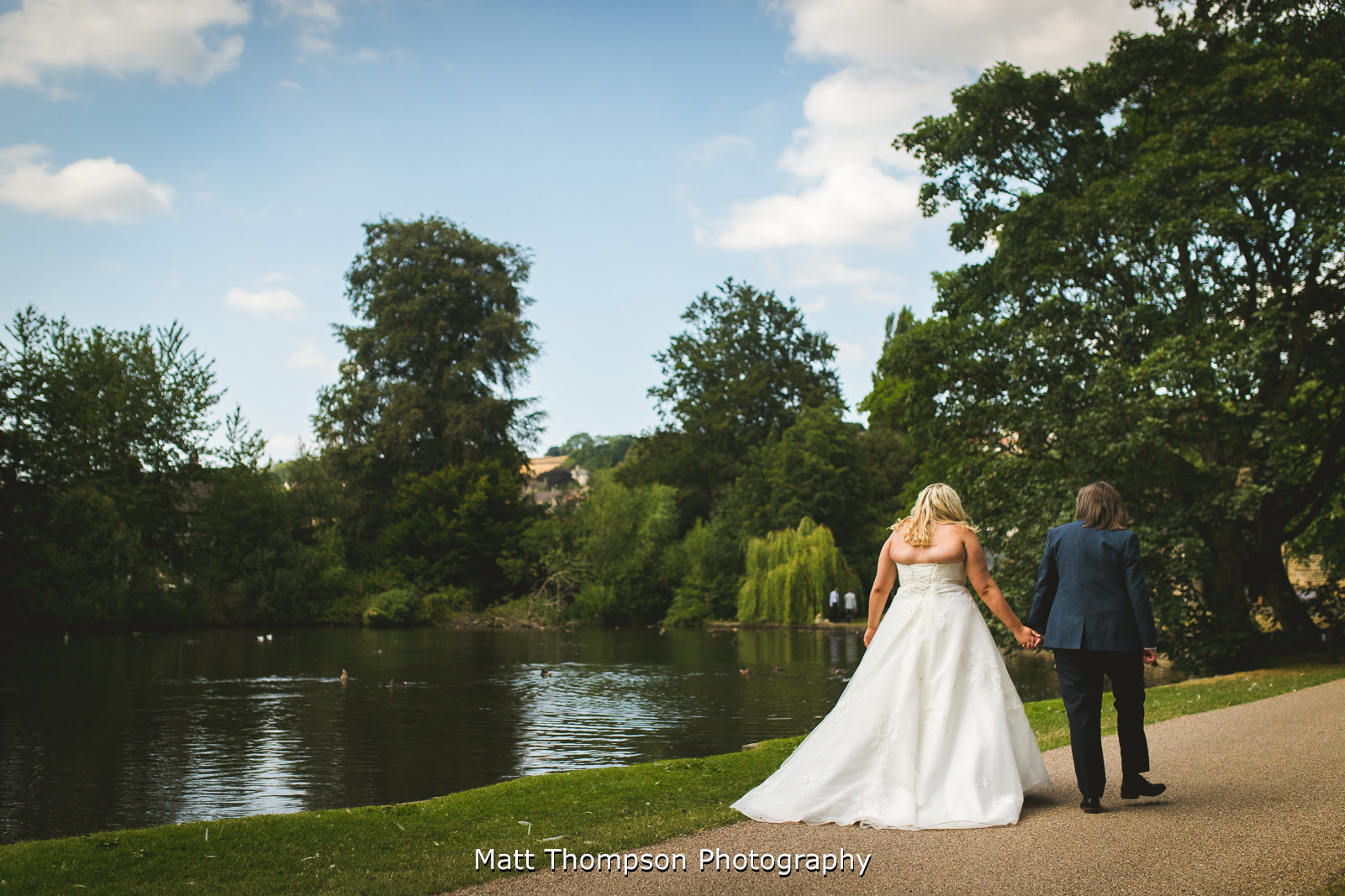 Wedding couple walking holding hands