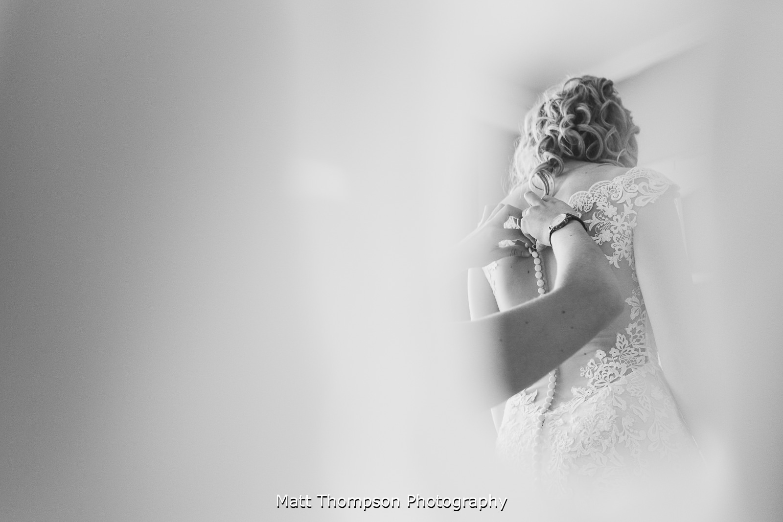 buttoning up the wedding dress