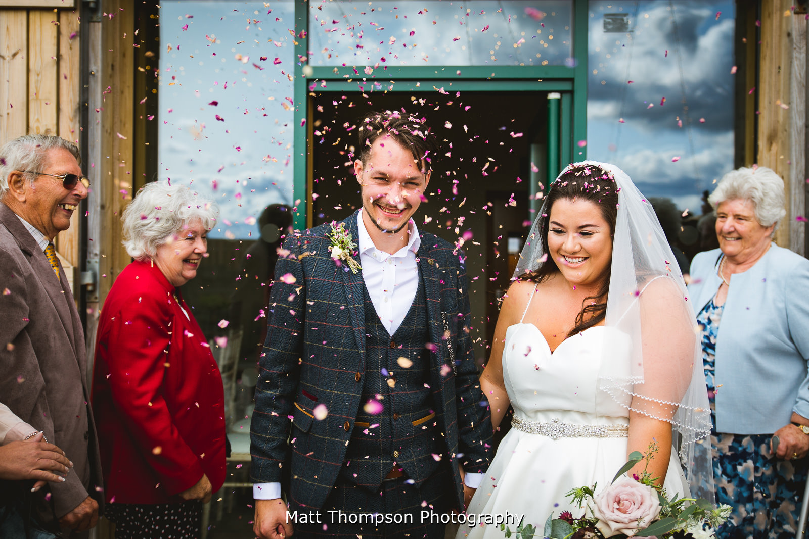 throwing confetti at bride and groom