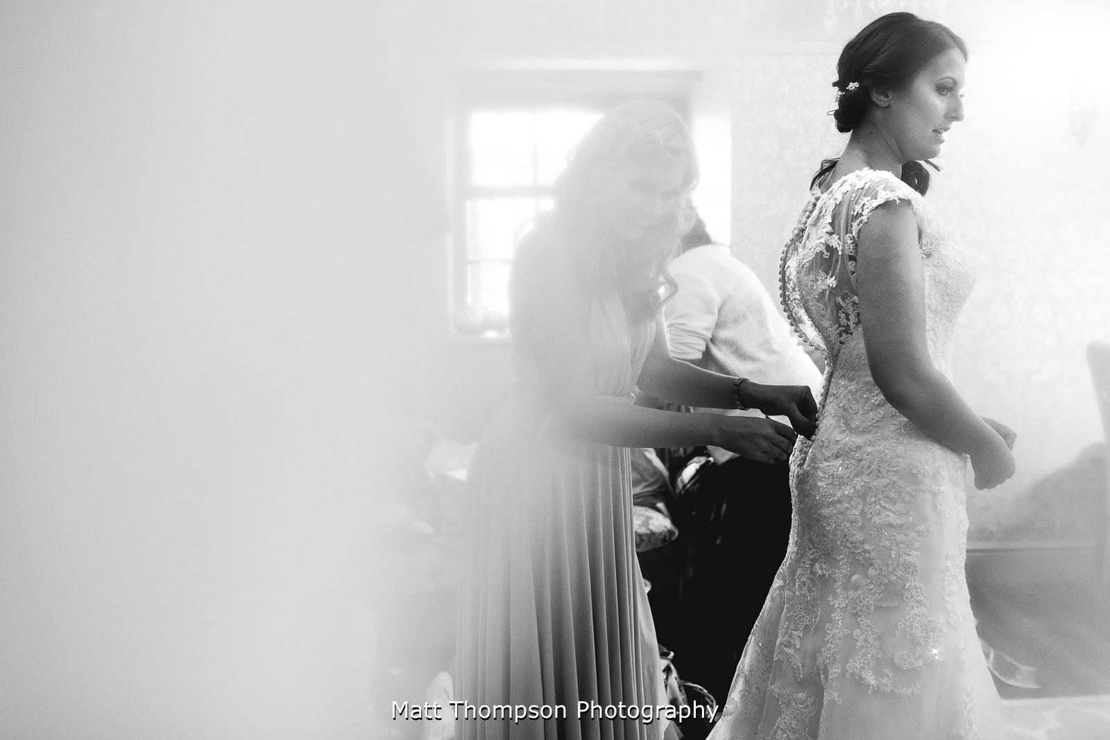 Buttoning up wedding dress