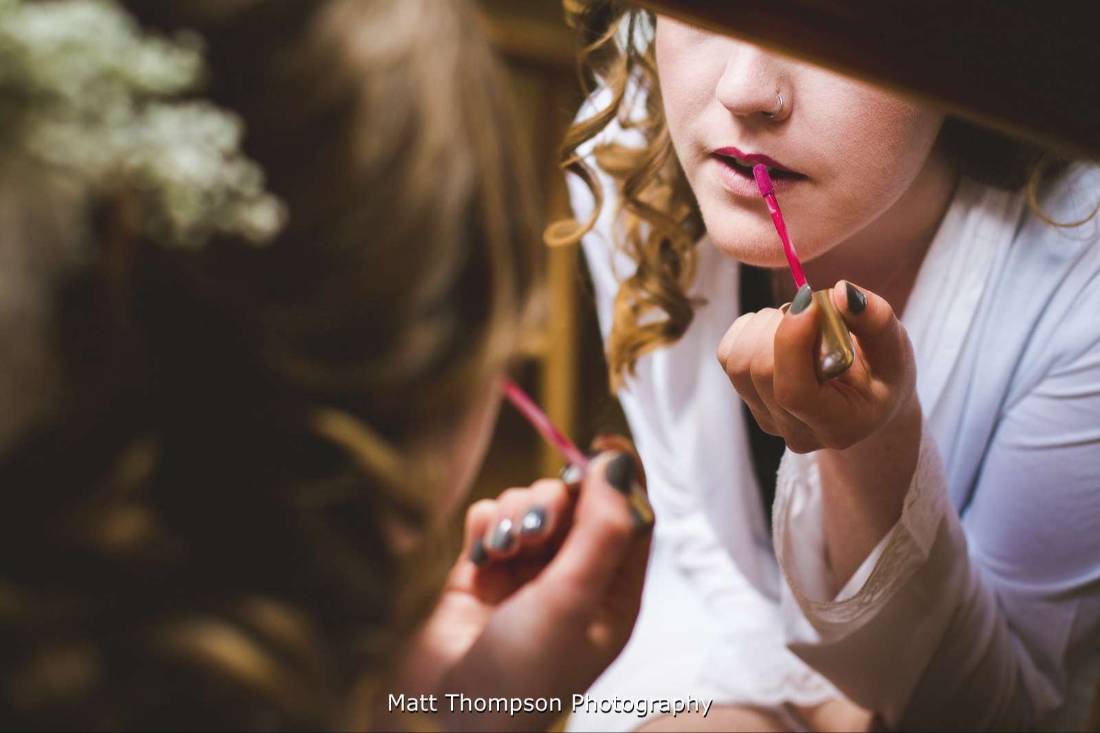 Putting lip gloss on