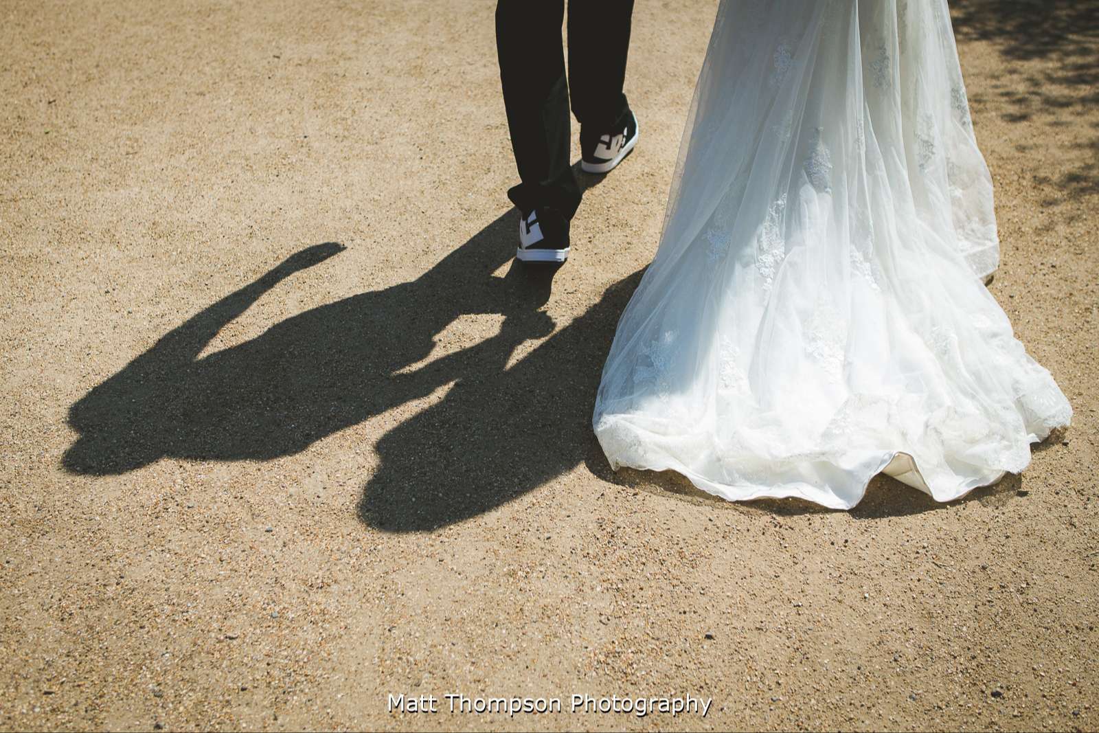 Holding hands and wedding dress