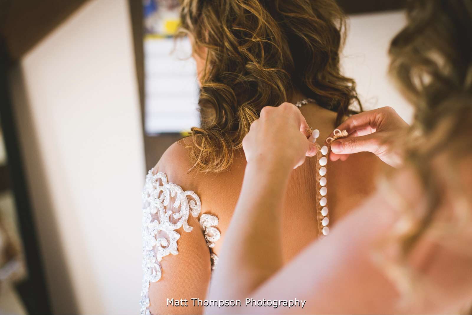 Buttoning up wedding dress