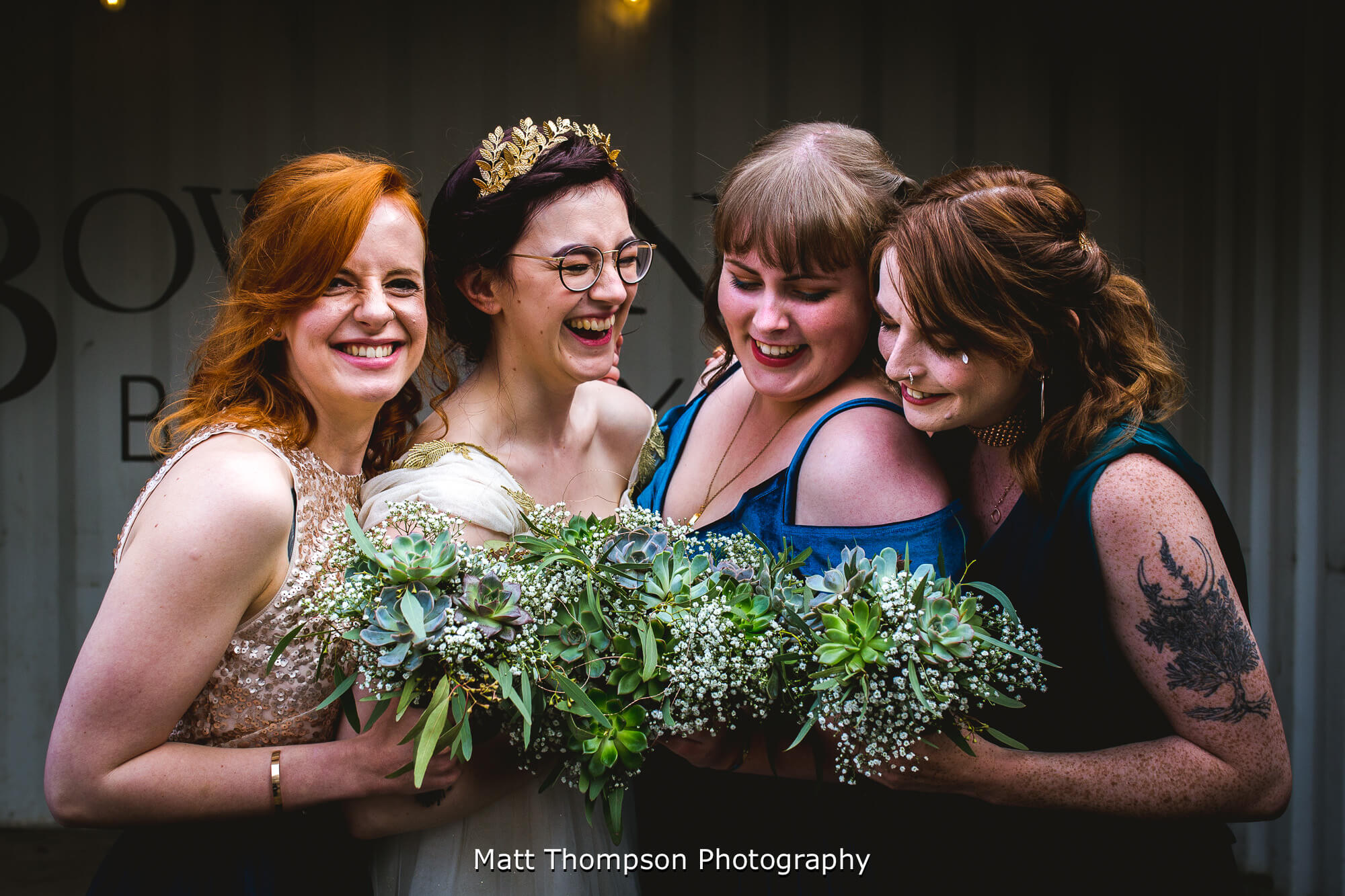Bride and bridesmaids laughing