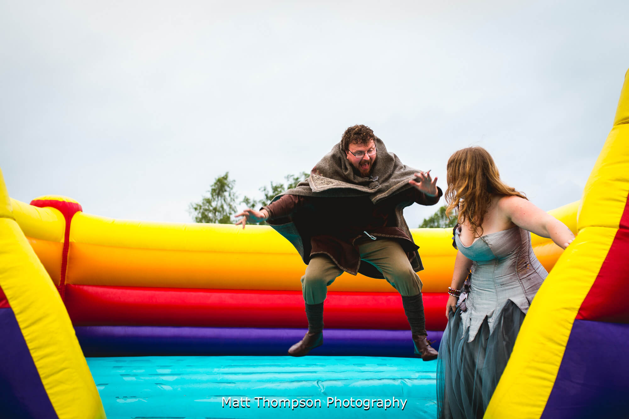 Bride and groom on a bouncy castle