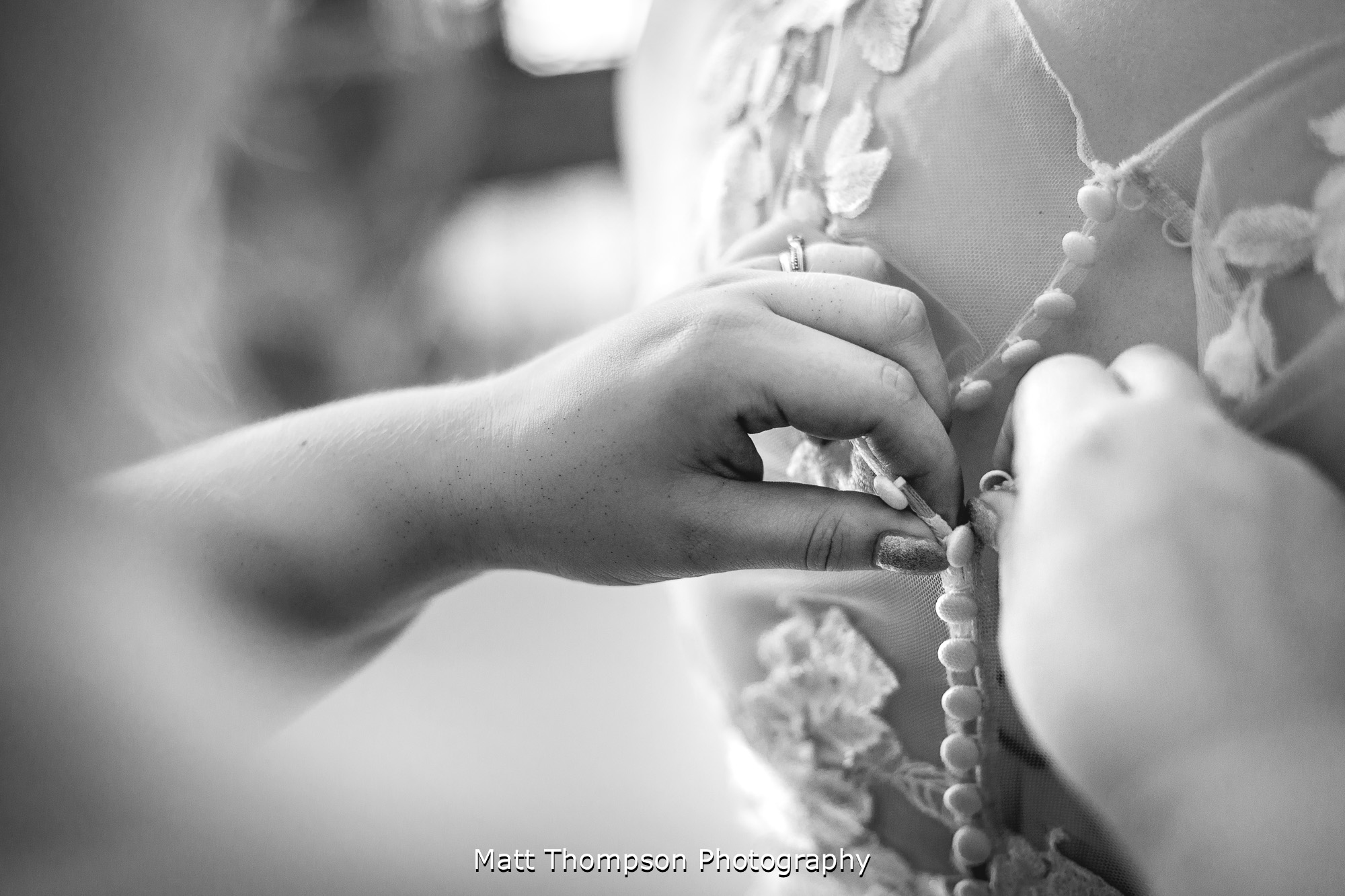 buttoning up the wedding dress