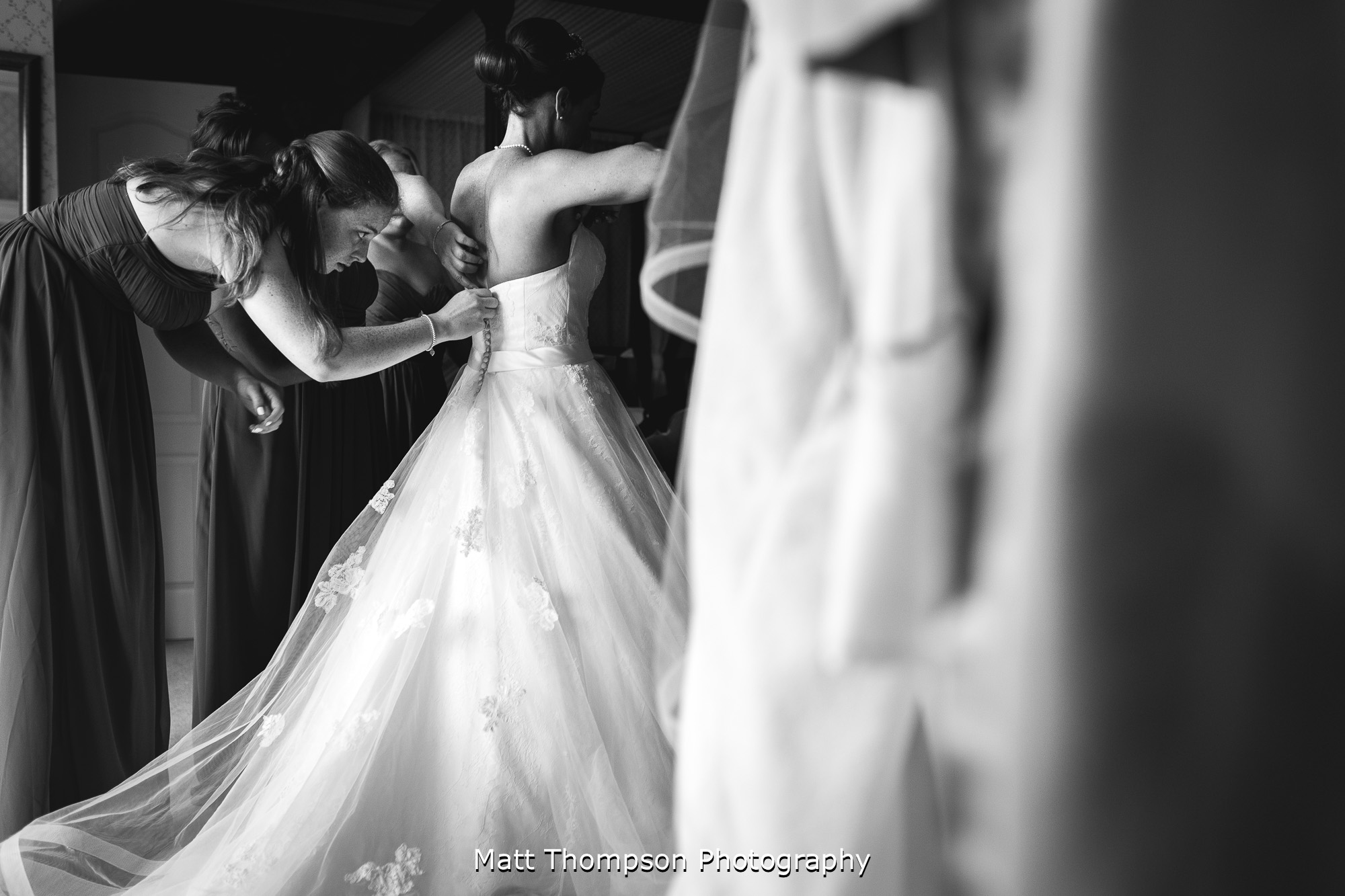 bridesmaids doing wedding dress