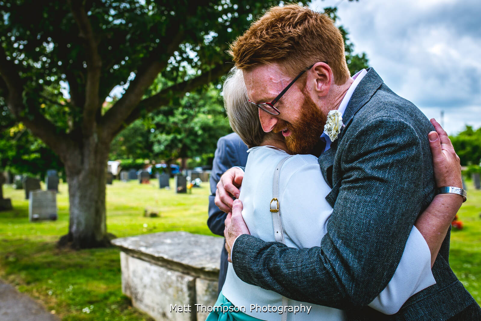 groom hugging wedding guests