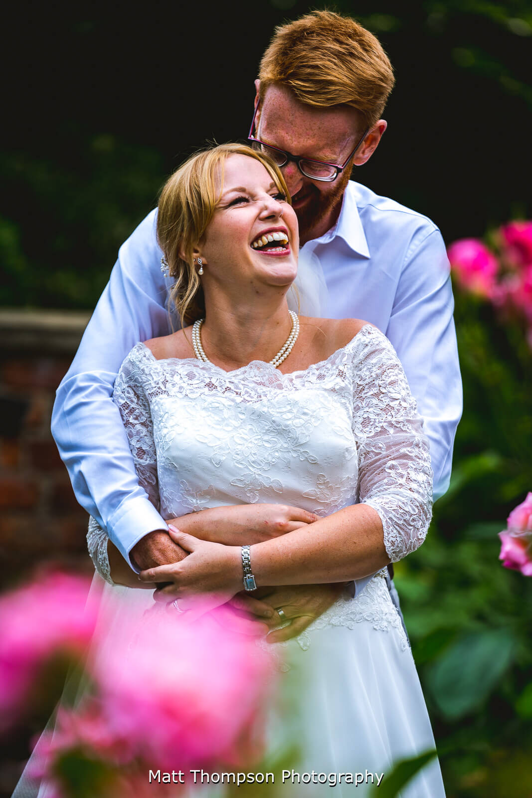 Bride and groom cuddling