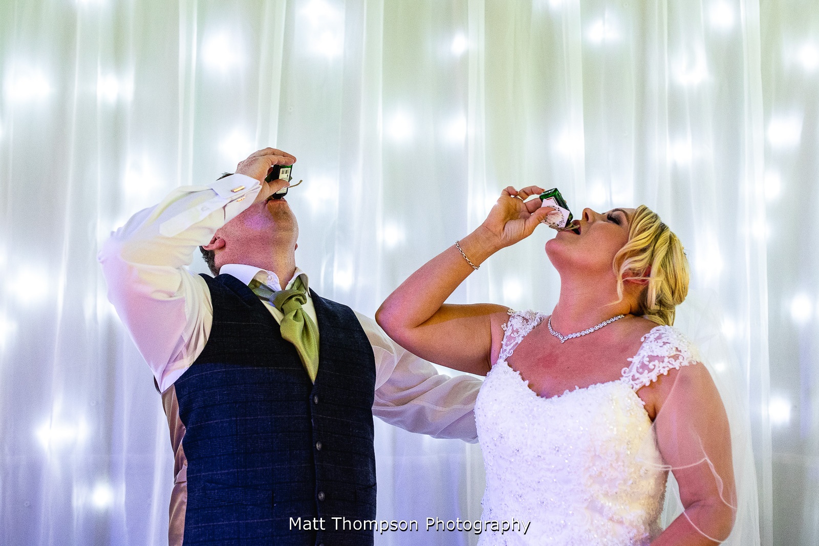 bride and groom doing shots