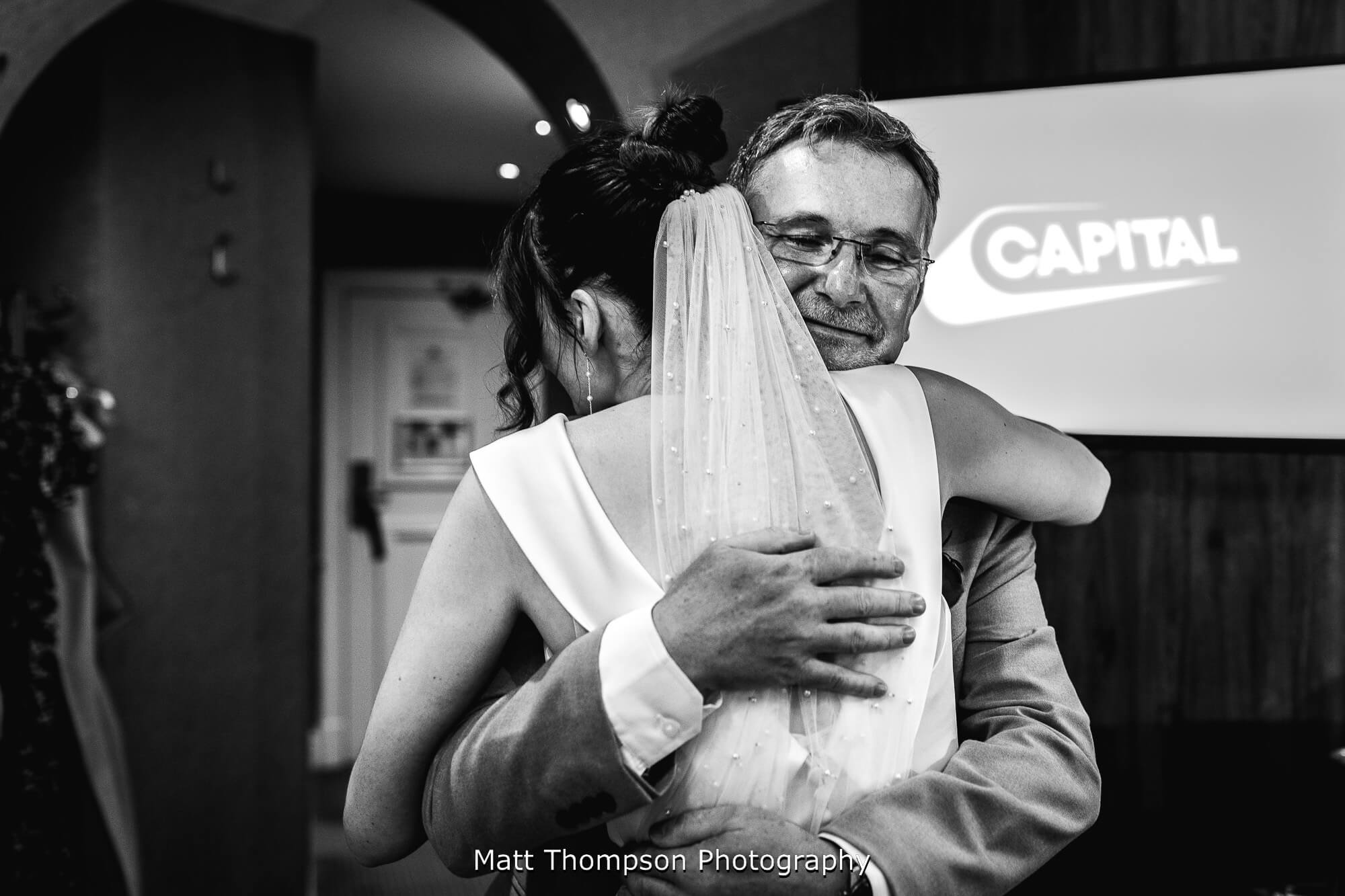 father of the bride hugging