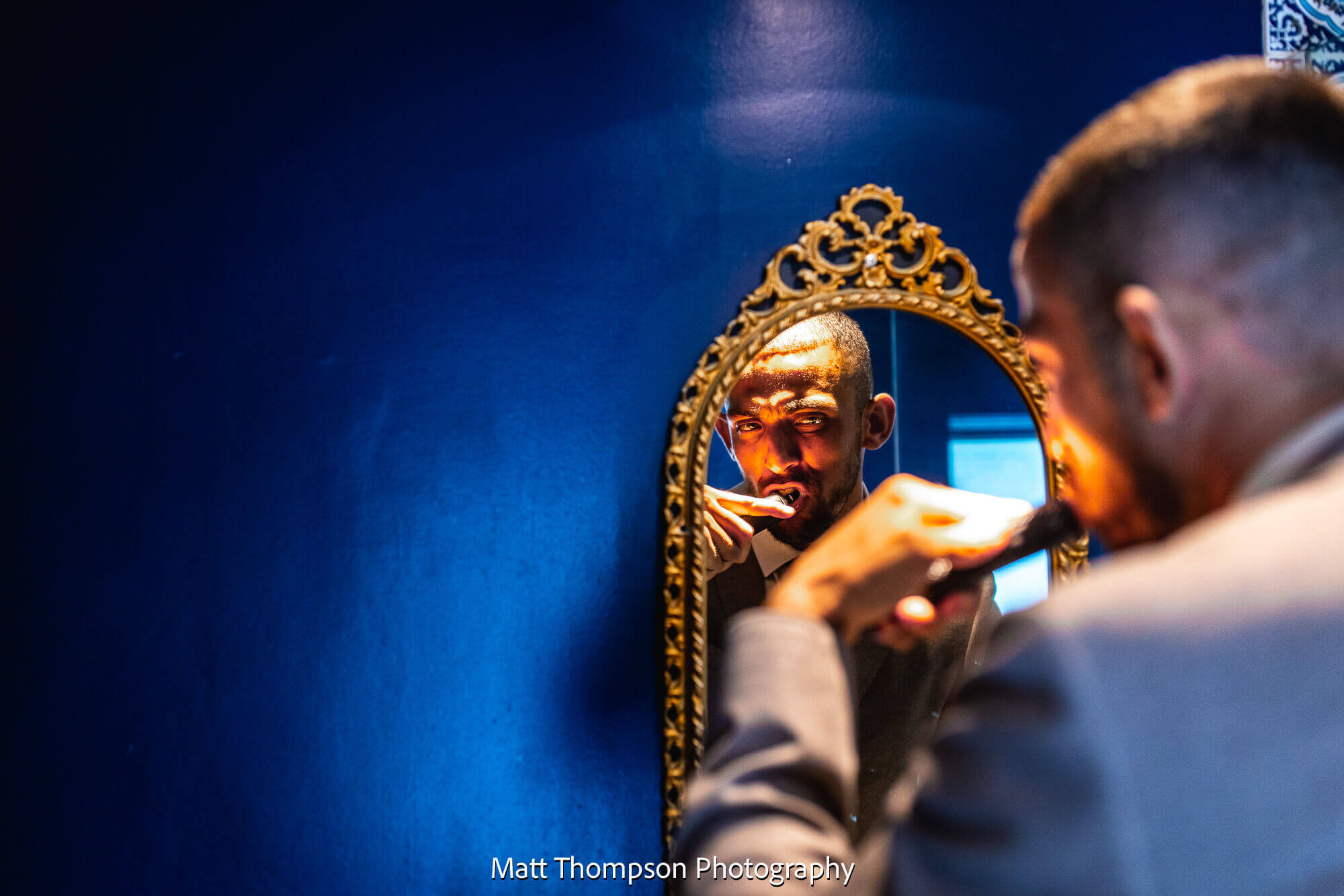 groom brushing teeth