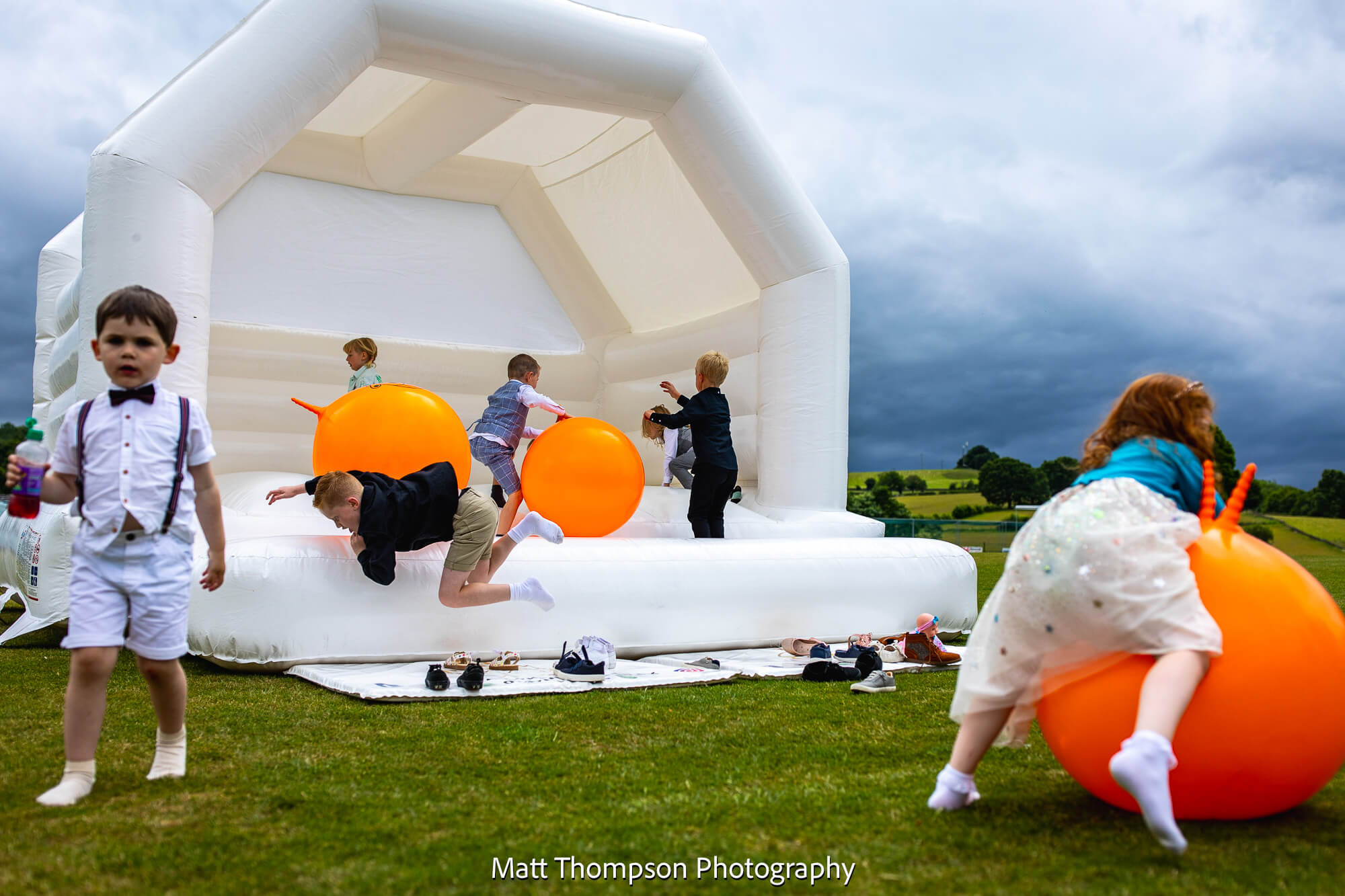 kids on wedding bouncy castle