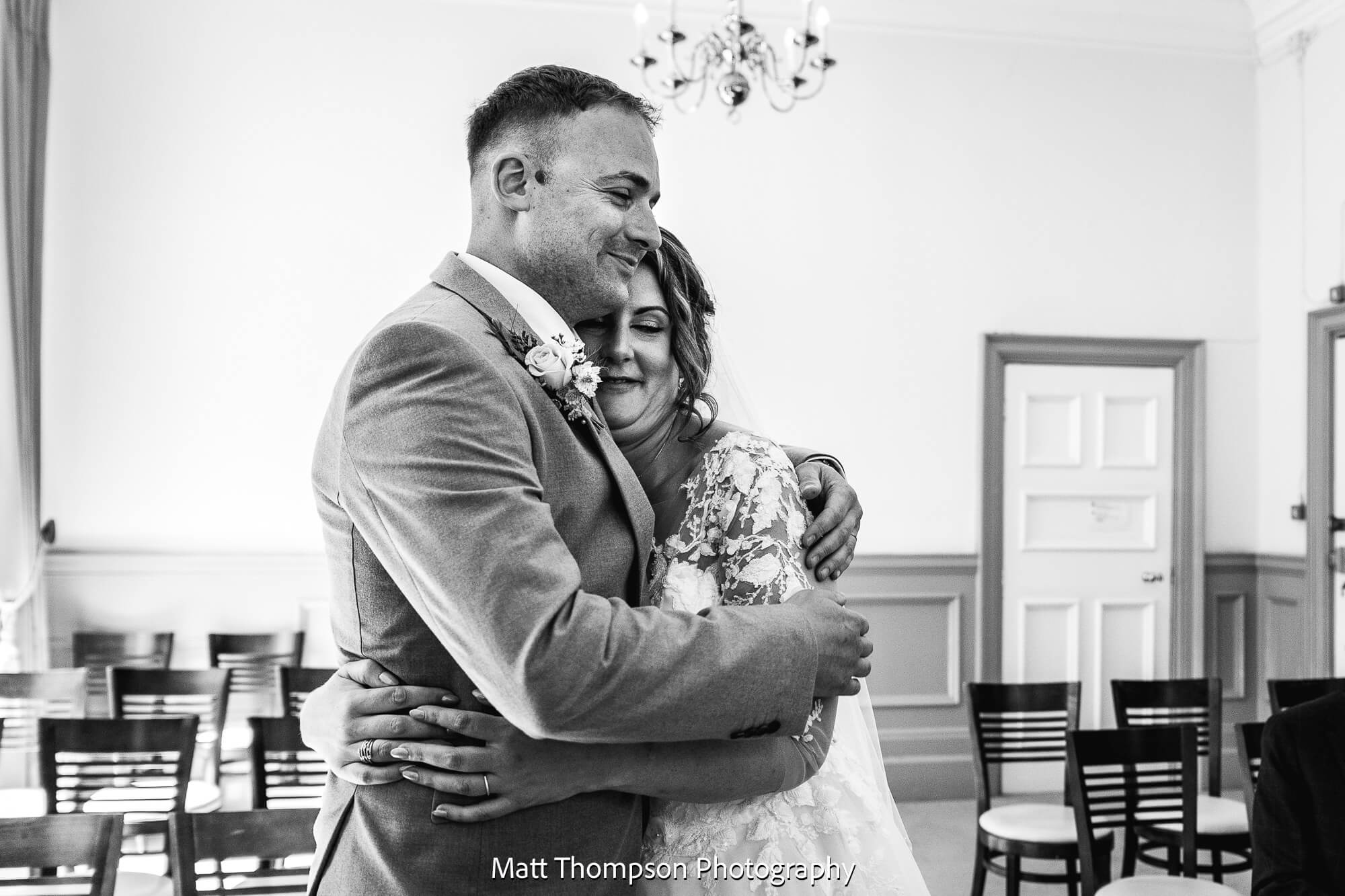 bride and groom hugging